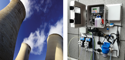 Planta industrial con torres de refrigeración junto a un sistema de telecontrol de parámetros del agua instalado en una pared